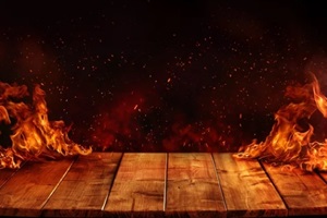 pressure-treated wooden table with fire burn at the edge of the table